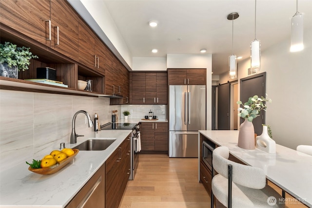 11903 NE 128th St Unit 612, Kirkland, WA 98034 - kitchen with appliances with stainless steel finishes, open shelves, backsplash, light wood finished floors, and pendant lighting