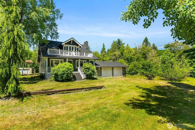 6928 View Park Rd SE, Port Orchard, WA 98367 - view of front of house with a front lawn, an attached garage, a balcony, and a chimney