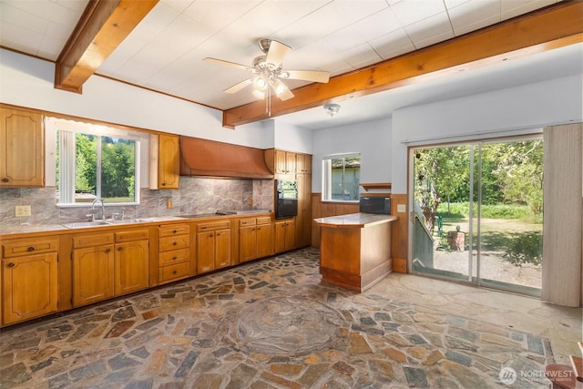 6928 View Park Rd SE, Port Orchard, WA 98367 - kitchen with stone floors, black appliances, premium range hood, tasteful backsplash, and beamed ceiling
