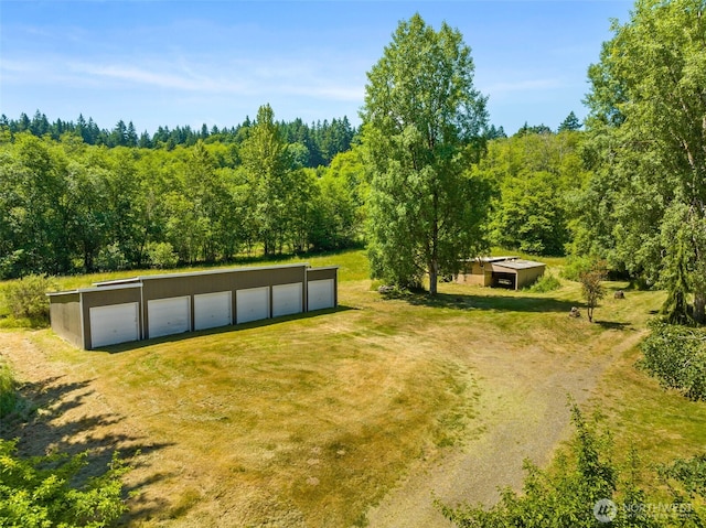 6928 View Park Rd SE, Port Orchard, WA 98367 - view of property's community with an outbuilding, driveway, a forest view, and a detached garage