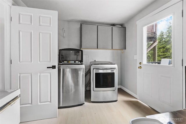 60 E Olyview Pl, Grapeview, WA 98546 - laundry room with cabinet space, washing machine and clothes dryer, and light wood-type flooring