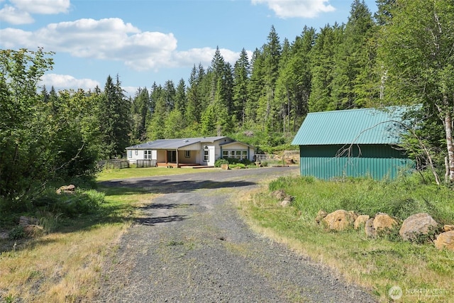 801 Hemlock Rd, Carson, WA 98610 - view of front of house featuring gravel driveway, a view of trees, and a metal roof