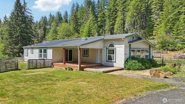 801 Hemlock Rd, Carson, WA 98610 - back of house featuring a metal roof, a view of trees, and a wooden deck
