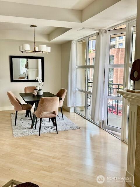 10047 Main St Unit 319, Bellevue, WA 98004 - dining area featuring wood finished floors and a chandelier