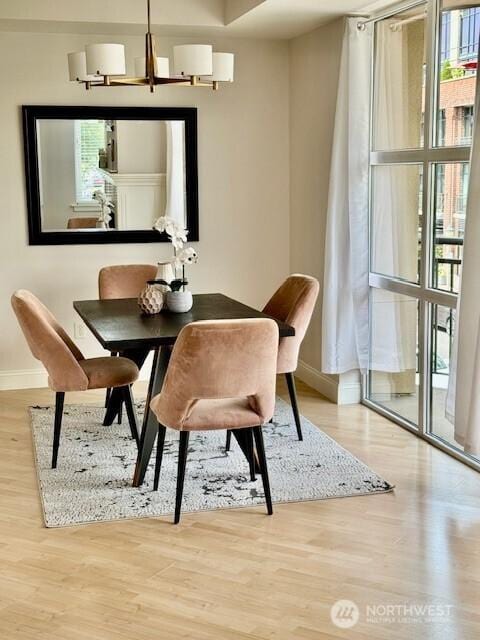 10047 Main St Unit 319, Bellevue, WA 98004 - dining space with healthy amount of natural light, wood finished floors, and a chandelier