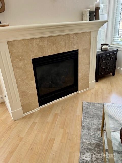 10047 Main St Unit 319, Bellevue, WA 98004 - detailed view of a tiled fireplace and wood finished floors