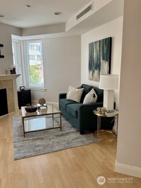 10047 Main St Unit 319, Bellevue, WA 98004 - living area featuring wood finished floors and a fireplace