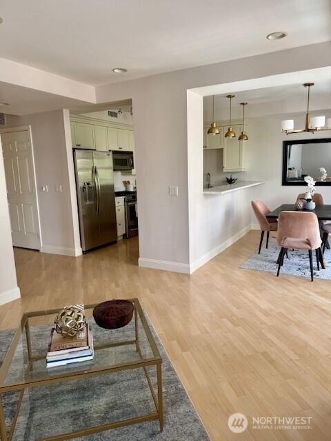 10047 Main St Unit 319, Bellevue, WA 98004 - living area featuring light wood-style floors and recessed lighting