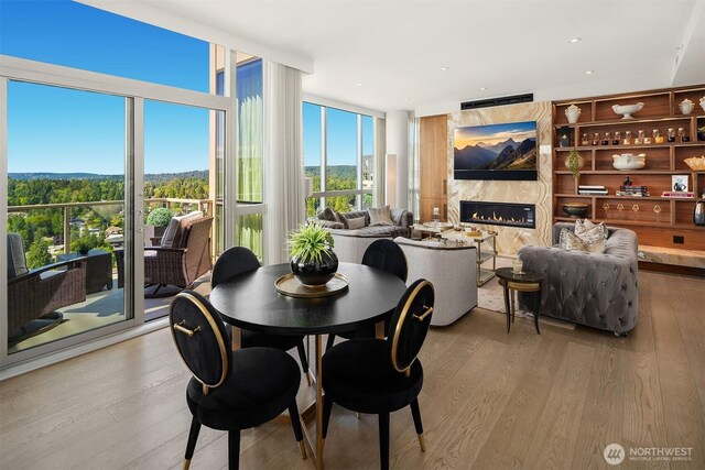 10650 NE 9th Pl Unit 2524, Bellevue, WA 98004 - dining room with floor to ceiling windows, wood finished floors, and a high end fireplace