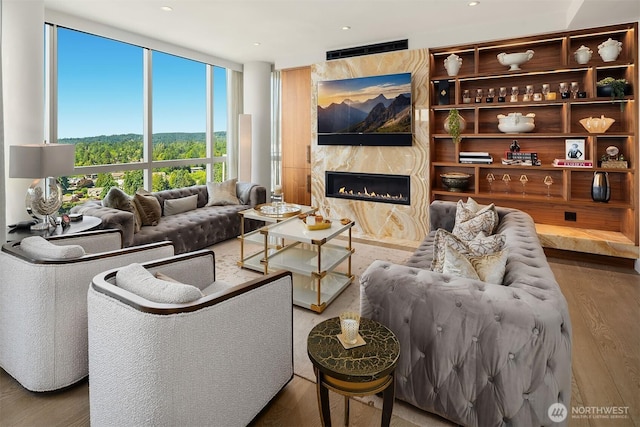 10650 NE 9th Pl Unit 2524, Bellevue, WA 98004 - living area with wood finished floors, a premium fireplace, floor to ceiling windows, and recessed lighting