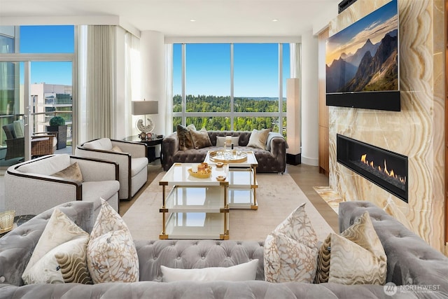 10650 NE 9th Pl Unit 2524, Bellevue, WA 98004 - living room featuring a tiled fireplace, wood finished floors, and expansive windows