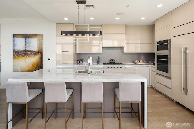 10650 NE 9th Pl Unit 2524, Bellevue, WA 98004 - kitchen with modern cabinets, paneled fridge, double oven, a breakfast bar, and light stone countertops