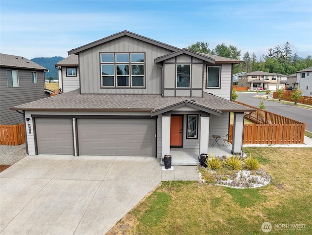298 Hovey St, Buckley, WA 98321 - view of front of home featuring an attached garage, driveway, a shingled roof, and board and batten siding