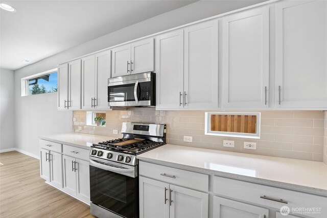 298 Hovey St, Buckley, WA 98321 - kitchen featuring appliances with stainless steel finishes, white cabinetry, and light countertops
