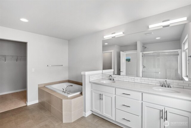 298 Hovey St, Buckley, WA 98321 - full bathroom with a stall shower, double vanity, a bath, a spacious closet, and tile patterned flooring