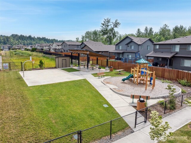 298 Hovey St, Buckley, WA 98321 - fenced backyard with a residential view, a storage shed, a playground, a patio, and a pergola