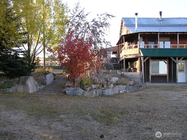 361 Rehmke Rd, Tonasket, WA 98855 - view of side of property with a metal roof and a wooden deck