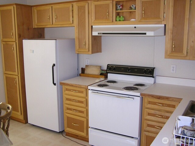 361 Rehmke Rd, Tonasket, WA 98855 - kitchen with white appliances, range hood, light countertops, and light flooring