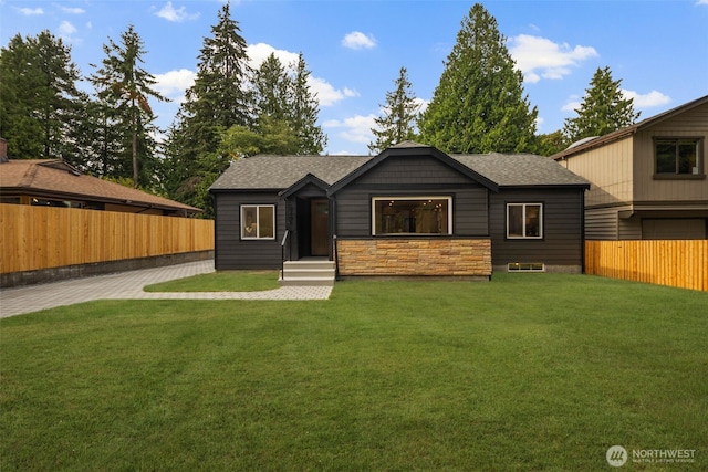 840 NE 100th St Unit A, Seattle, WA 98125 - view of front of house featuring roof with shingles, a fenced backyard, and stone siding
