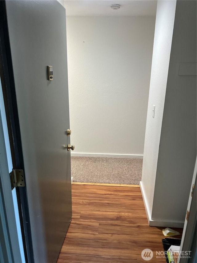 4800 200th St SW Unit E205, Lynnwood, WA 98036 - hallway featuring baseboards and wood finished floors