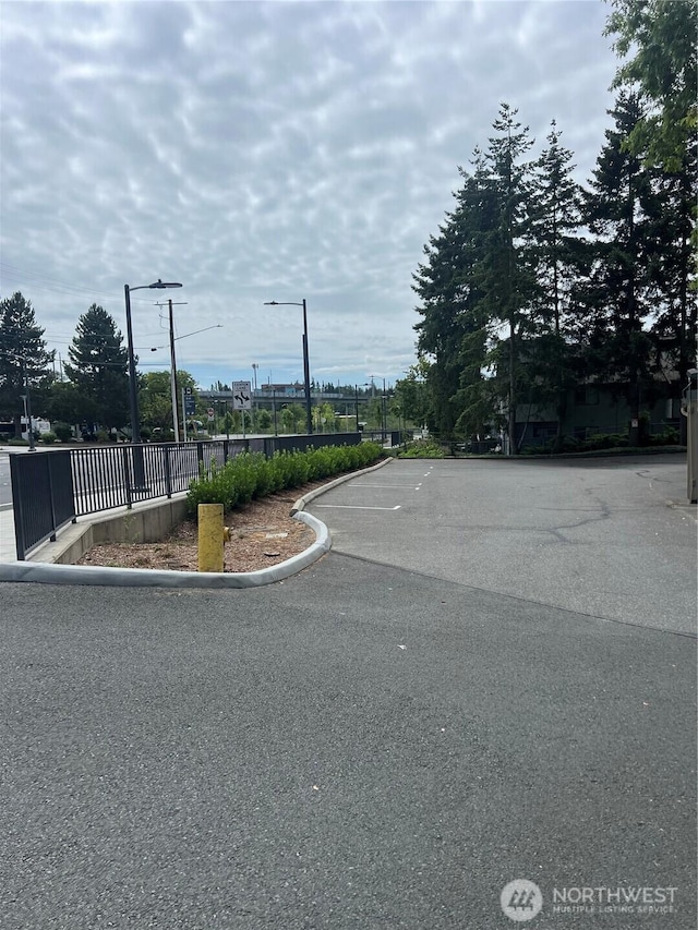 4800 200th St SW Unit E205, Lynnwood, WA 98036 - view of asphalt street featuring street lights and curbs