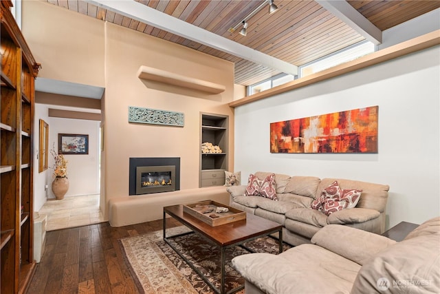 7623 NE 123rd St, Kirkland, WA 98034 - living room with dark wood-style flooring, a wooden ceiling with exposed beams, built in shelves, and a glass covered fireplace