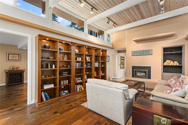7623 NE 123rd St, Kirkland, WA 98034 - living room featuring track lighting, a wooden ceiling with exposed beams, a towering ceiling, wood finished floors, and a glass covered fireplace