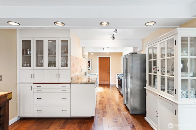 7623 NE 123rd St, Kirkland, WA 98034 - kitchen with appliances with stainless steel finishes, light stone countertops, white cabinetry, wood finished floors, and recessed lighting