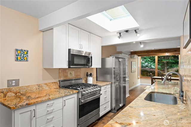 7623 NE 123rd St, Kirkland, WA 98034 - kitchen featuring high end appliances, a skylight, dark wood-style flooring, and light stone countertops