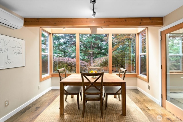 7623 NE 123rd St, Kirkland, WA 98034 - dining area featuring a wall unit AC, light wood finished floors, and beamed ceiling