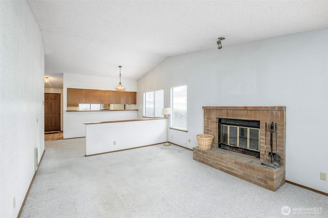 25036 110th Ave SE Unit 25A, Kent, WA 98030 - unfurnished living room featuring light carpet, vaulted ceiling, and a fireplace