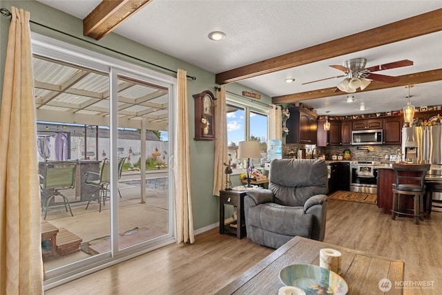 327 N Grape Dr, Moses Lake, WA 98837 - living room with beam ceiling, light wood-style floors, and ceiling fan
