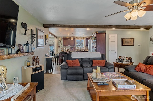 327 N Grape Dr, Moses Lake, WA 98837 - living area with beamed ceiling, a ceiling fan, and light carpet