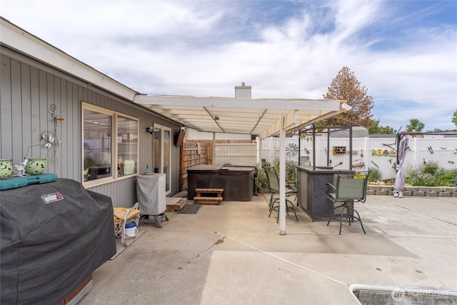 327 N Grape Dr, Moses Lake, WA 98837 - fenced backyard with a hot tub, a patio, and outdoor dining space