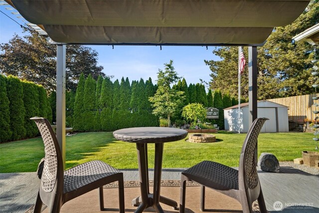 16 NW 23rd St, Battle Ground, WA 98604 - view of patio featuring a storage unit and an outdoor fire pit
