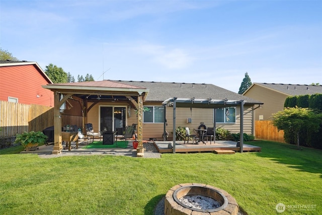 16 NW 23rd St, Battle Ground, WA 98604 - back of property featuring an outdoor fire pit, a deck, a pergola, a fenced backyard, and a patio area