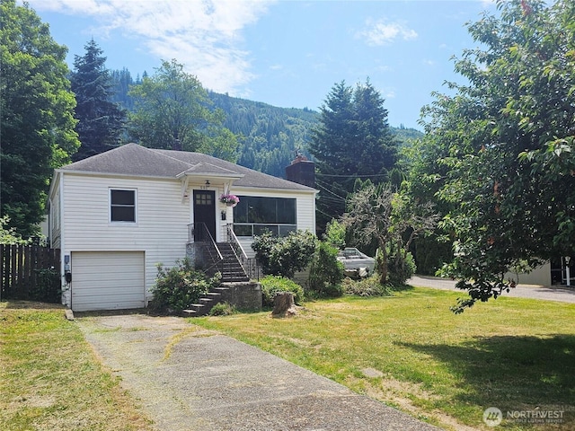 591 Division Ave, Morton, WA 98356 - view of front of property featuring driveway, an attached garage, a chimney, and a forest view