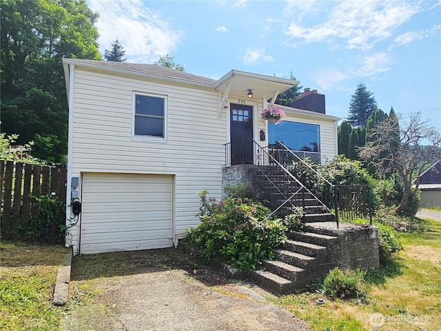 591 Division Ave, Morton, WA 98356 - view of front of property featuring a chimney, an attached garage, and dirt driveway