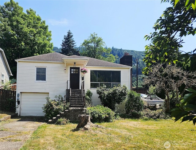 591 Division Ave, Morton, WA 98356 - view of front of home featuring driveway, a chimney, and a garage