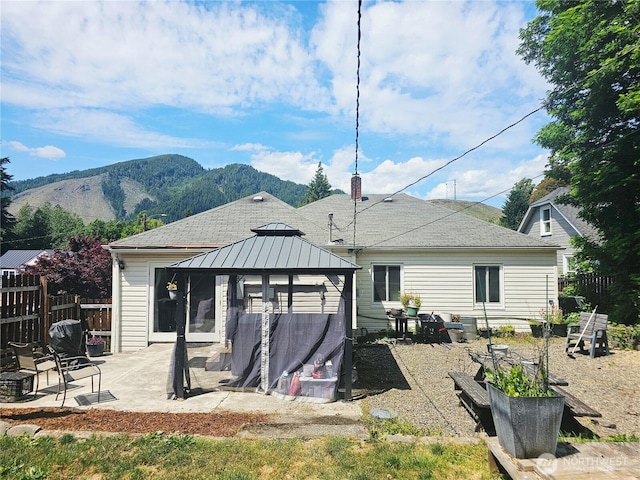 591 Division Ave, Morton, WA 98356 - back of property with a gazebo, a patio, a mountain view, a vegetable garden, and roof with shingles