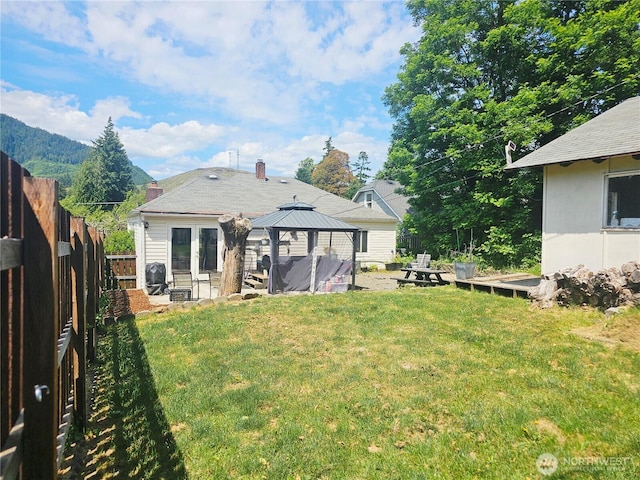 591 Division Ave, Morton, WA 98356 - rear view of property with a gazebo, a fenced backyard, a patio area, and a chimney