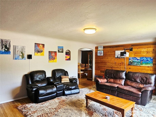 591 Division Ave, Morton, WA 98356 - living area featuring arched walkways, wood finished floors, and a textured ceiling