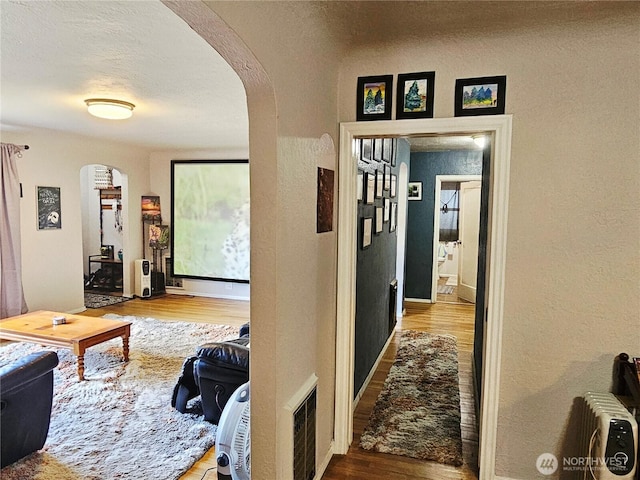 591 Division Ave, Morton, WA 98356 - hall with arched walkways, wood finished floors, and a textured wall