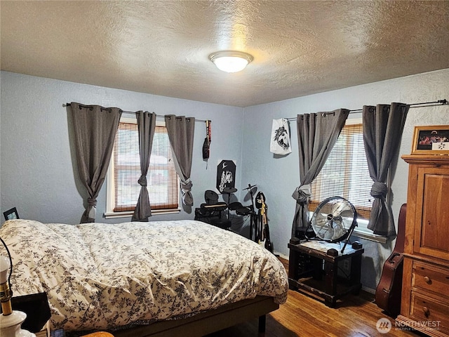 591 Division Ave, Morton, WA 98356 - bedroom featuring wood finished floors, a textured ceiling, and a textured wall