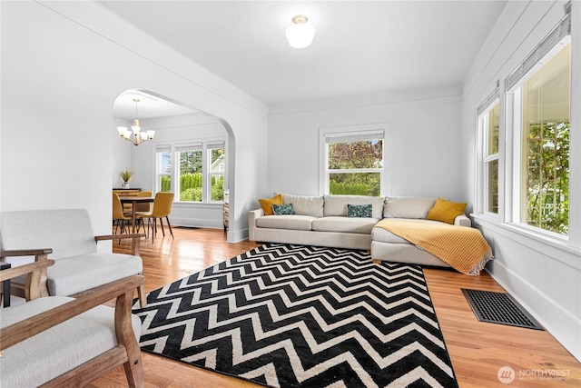 1584 Main St, Lynden, WA 98264 - living area featuring arched walkways, wood finished floors, and a chandelier