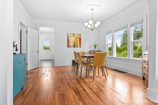 1584 Main St, Lynden, WA 98264 - dining area with hardwood / wood-style flooring, a chandelier, and crown molding