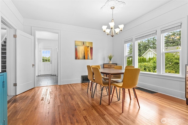 1584 Main St, Lynden, WA 98264 - dining space featuring a chandelier, hardwood / wood-style flooring, plenty of natural light, and crown molding