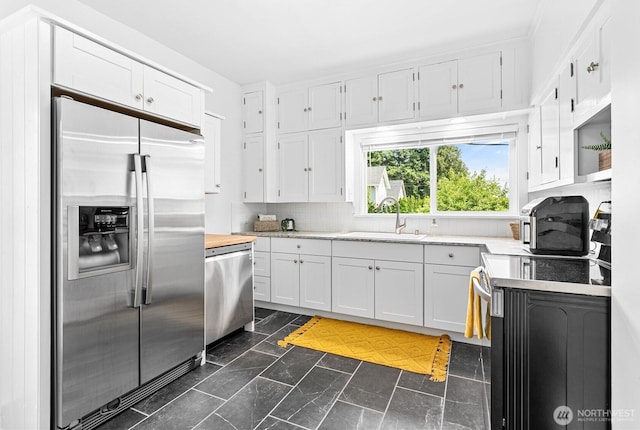 1584 Main St, Lynden, WA 98264 - kitchen featuring appliances with stainless steel finishes, white cabinets, and backsplash