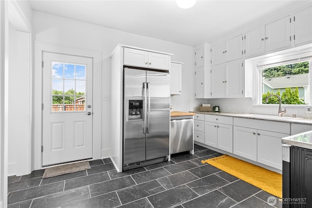 1584 Main St, Lynden, WA 98264 - kitchen featuring stainless steel appliances, healthy amount of natural light, white cabinets, and light countertops