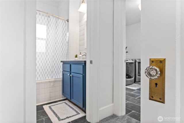 1584 Main St, Lynden, WA 98264 - bathroom with washing machine and clothes dryer, a shower with shower curtain, and vanity